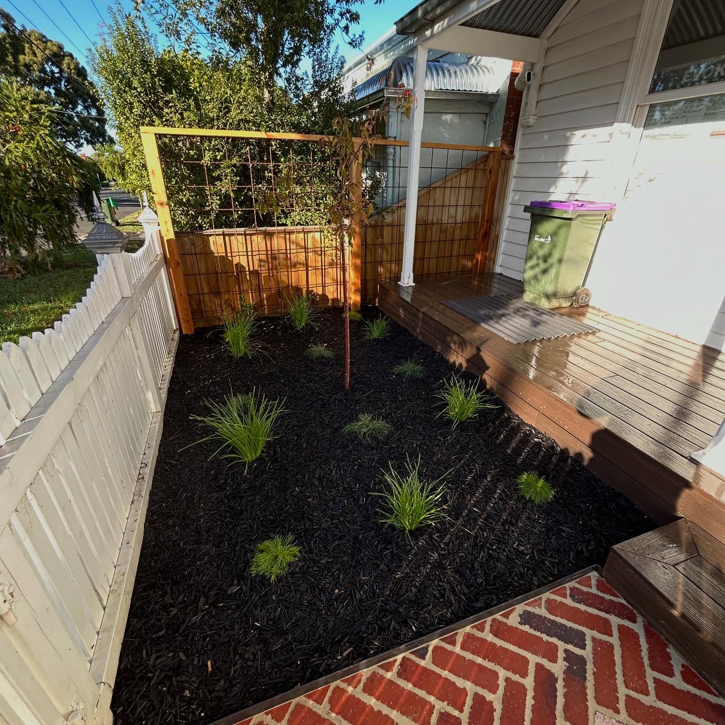 Low-maintenance front yard with red brick path / 2